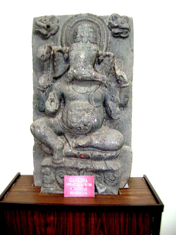 A temple site now represented only by a mound with statues of Ganesh and Nandi on it — photograph 3